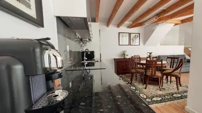 a kitchen with a table and a dining room at T3 Centro de Albufeira com piscina in Albufeira