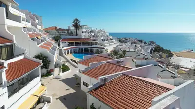 arial view of a city with houses and the ocean at T3 Centro de Albufeira com piscina in Albufeira