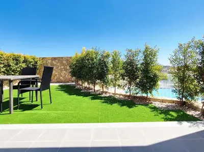 a yard with a table and chairs and a green lawn at Vistas Mar Villas D by Stay ici Algarve Holiday Rental in Albufeira