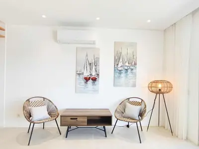 a living room with two chairs and a coffee table at Vistas Mar Villas D by Stay ici Algarve Holiday Rental in Albufeira