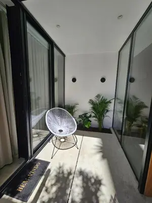 a white chair sitting on the balcony of a building at The Singular - Downtown Studio in Faro