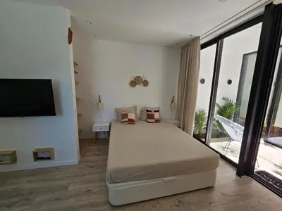 a bedroom with a bed and a flat screen tv at The Singular - Downtown Studio in Faro