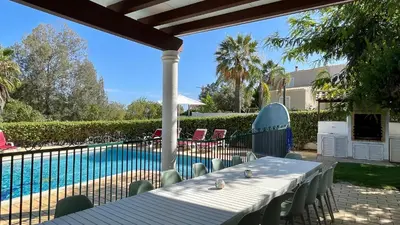 a table and chairs next to a swimming pool at Poço by Check-in Portugal in Albufeira