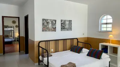 a bedroom with a bed with three pictures on the wall at Poço by Check-in Portugal in Albufeira