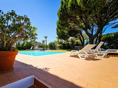 a pool with two lounge chairs and a table at FLH Quinta das Salinas Triplex with Terrace & Pool in Vale do Lobo