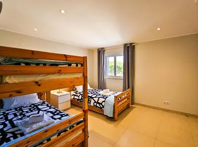 a bedroom with two bunk beds and a window at FLH Quinta das Salinas Triplex with Terrace & Pool in Vale do Lobo