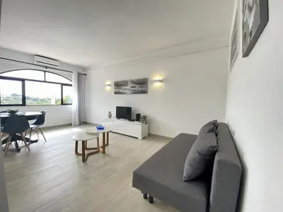 a living room with a couch and a table at Albufeira Central 6 by Homing in Albufeira