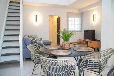 a living room with a table and chairs at Martina Apartment - SeaView in Albufeira