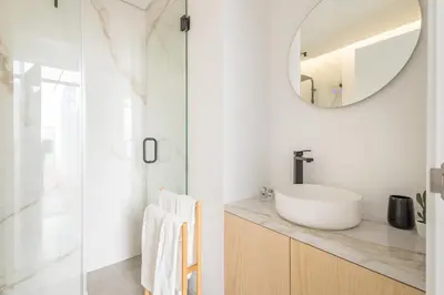 a bathroom with a sink and a mirror at LODO Suites Ria - Private Room by HD in Faro