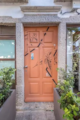 an orange front door of a house at LODO Suites Ria - Private Room by HD in Faro