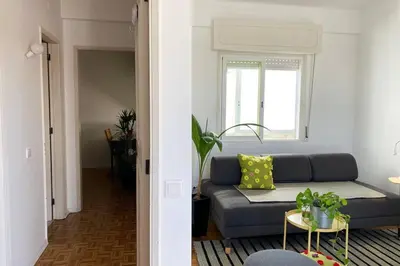 a living room with a couch and a table at Superstar terrace in Faro