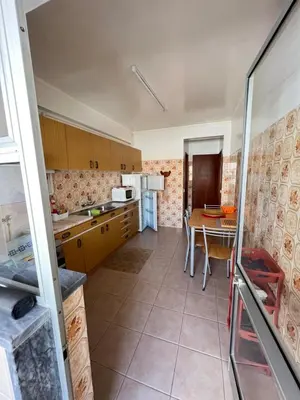 a kitchen with a table and a dining room at CENTER HOUSE in Faro