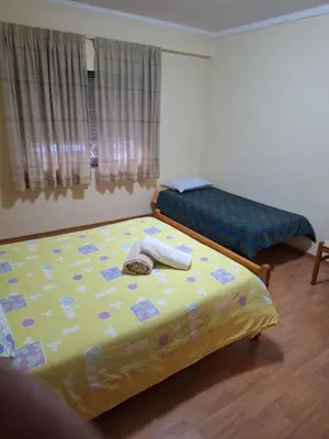 a bedroom with two beds with towels on it at CENTER HOUSE in Faro