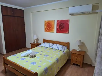 a bedroom with a bed and two lamps and two paintings at CENTER HOUSE in Faro