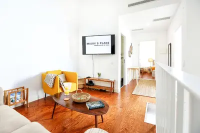 a living room with a couch and a table at Ria Formosa Vista Duplex Charm in downtown Faro in Faro