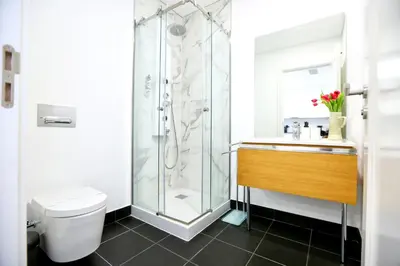 a bathroom with a shower and a toilet and a sink at Ria Formosa Vista Duplex Charm in downtown Faro in Faro