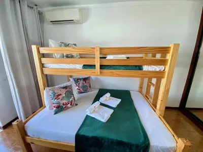 a bunk bed in a room with two beds at Quarteira Beach Apartment by Homing in Quarteira