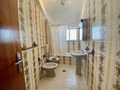 a bathroom with a toilet and a sink at Quarteira Beach Apartment by Homing in Quarteira
