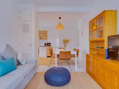 a living room with a couch and a table at AL - Apartamento Montemar in Vilamoura