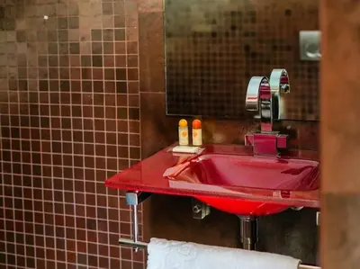 a red sink in a bathroom with a mirror at Dunas Salgados Apartment by Stay ici Algarve Holiday Rental in Albufeira