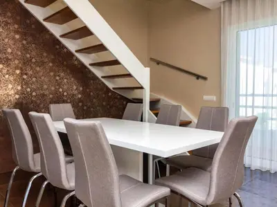 a dining room with a white table and chairs at Dunas Salgados Apartment by Stay ici Algarve Holiday Rental in Albufeira