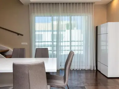 a dining room with a white table and chairs at Dunas Salgados Apartment by Stay ici Algarve Holiday Rental in Albufeira