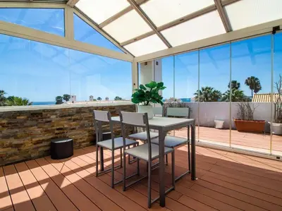 a patio with a table and chairs on a deck at Dunas Salgados Apartment by Stay ici Algarve Holiday Rental in Albufeira