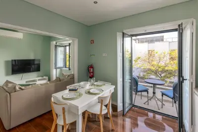 a living room with a white table and a couch at Mercado Apartments in Faro