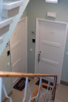 a room with a white door and a staircase at Mercado Apartments in Faro