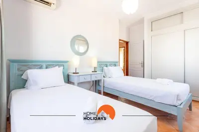 a bedroom with two beds and a mirror at #185 V3 Laranjeiras by Home Holidays in Albufeira
