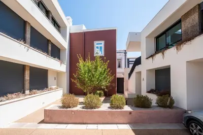 an apartment building with a tree in a courtyard at Diamond Downtown Center in Faro