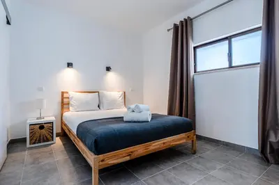 a bedroom with a bed and a window at Modern 2 BDR Flat W/Balcony and Pool by LovelyStay in Albufeira