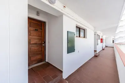 a hallway with a wooden door in a building at Modern 2 BDR Flat W/Balcony and Pool by LovelyStay in Albufeira