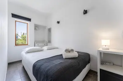 a bedroom with a bed with two towels on it at Modern 2 BDR Flat W/Balcony and Pool by LovelyStay in Albufeira