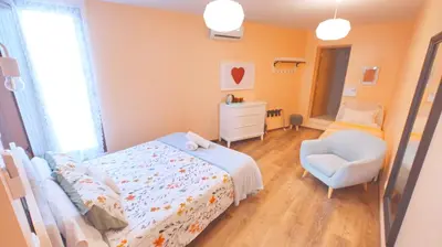 a bedroom with a bed and a chair at Sunlight House in Faro