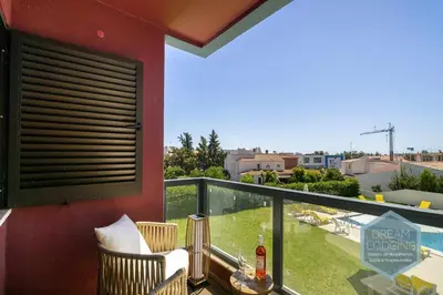a balcony with a table and chairs and a view of a city at Palm Tree - Dream Lodging in Albufeira
