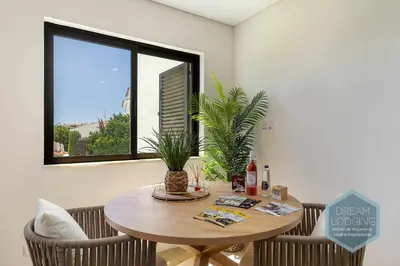 a dining room with a table and a window at Palm Tree - Dream Lodging in Albufeira