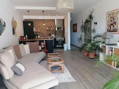 a living room with a couch and a kitchen at EMCA HOME Albufeira in Olhos de Água