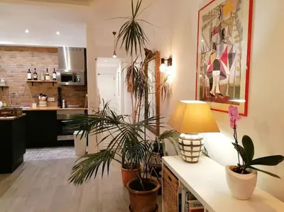 a kitchen with potted plants and a table with a lamp at EMCA HOME Albufeira in Olhos de Água