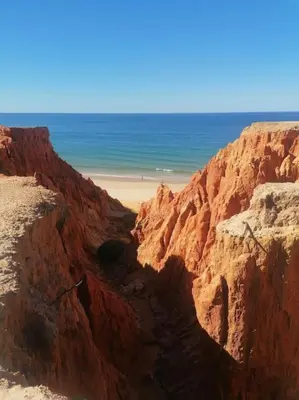 a view of the beach from a rocky cliff at EMCA HOME Albufeira in Olhos de Água