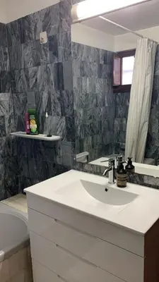 a bathroom with a sink and a mirror at Casa Calma in Albufeira