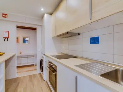 a kitchen with white cabinets and a sink at AL - Apartamento Moural in Quarteira