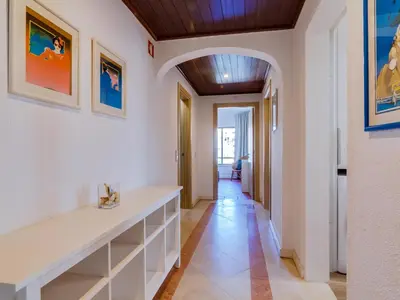a hallway with white walls and a wooden ceiling at AL - Apartamento Moural in Quarteira