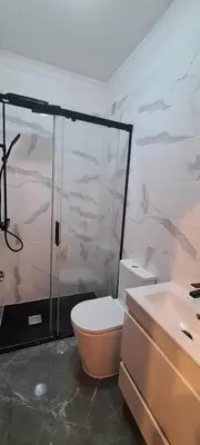 a bathroom with a shower and a toilet and a sink at Vilamoura-Quarteira Beaches Apt with pool and sea view in Quarteira