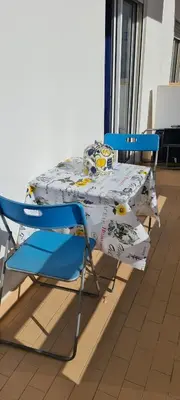 a table with two chairs and a box on it at Vilamoura-Quarteira Beaches Apt with pool and sea view in Quarteira