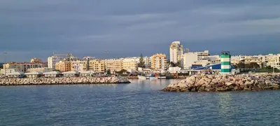 a view of a harbor with a city in the background at Vilamoura-Quarteira Beaches Apt with pool and sea view in Quarteira