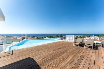 a swimming pool on the roof of a house at Stunning 3 BDR Flat W/ Rooftop Pool by LovelyStay in Albufeira