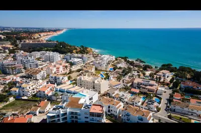 an aerial view of a city next to the ocean at Stunning 3 BDR Flat W/ Rooftop Pool by LovelyStay in Albufeira