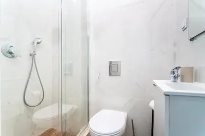 a bathroom with a shower and a toilet and a sink at Privilege Casa dos Capuchinhos, in the heart of Faro in Faro