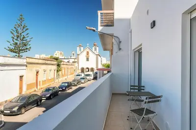 a balcony with a view of a street at Privilege Casa dos Capuchinhos, in the heart of Faro in Faro